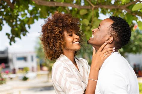 Outdoor Protrait Of African American Couple Kissing Each Other Stock