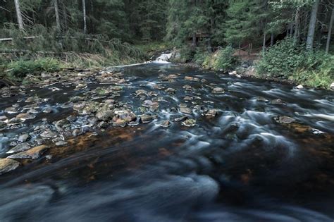 Premium Photo Milky Smooth Mountain River Flows Over Dark Stones