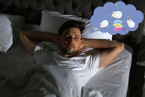 Man Trying To Fall Asleep Counting Sheep In Bed At Night Above View