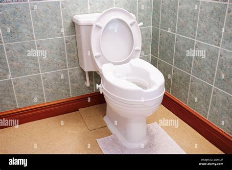 Toilet With Height Extension For Disabled Senior Person Indoors In