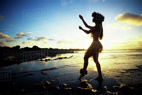 Hawaii Female Hula Dancer On Beach Silhouetted By Sunset