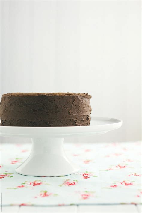 Chocolate Buttercream Chocolate Cake On White Cake Stand By Stocksy Contributor Kirsty Begg
