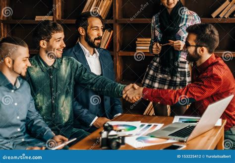 Advertising Manager With A Handshake Greets The Customer Stock Photo