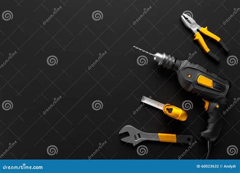 Drill Wrench And Construction Tools On The Black Background Stock