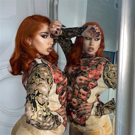 Two Women With Red Hair Are Standing In Front Of A Mirror