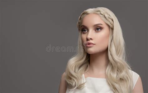 Portrait Of Blonde Girl With A Hairstyle From Braids Stock Photo