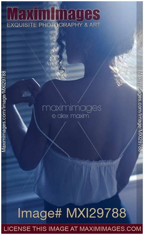 Photo Of Back Of Sexy Woman Undressing By The Window Taking Her Night Shirt Off Stock Image