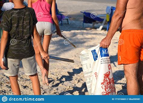 Volunteers Clean Beach To Collect The Cigarette Butts On The Beach Volunteers Proberutsya On