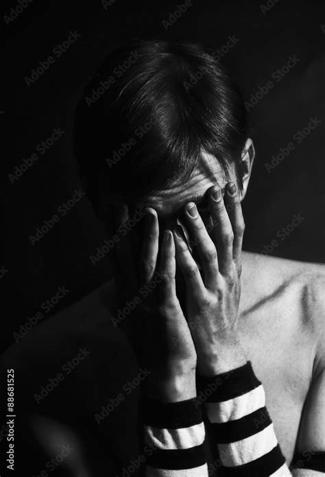Black And White Portrait Of Young Man Crying Covering The Face Stock