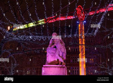 Christmas Lights Bathe The Statue In Leicester Square During The