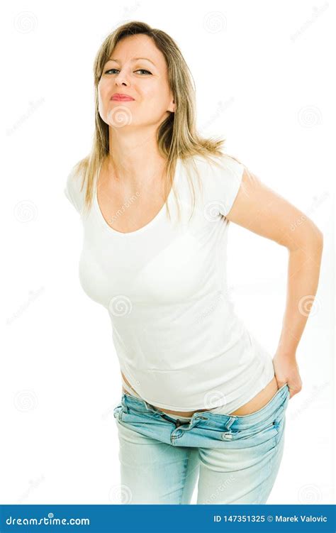 Blond Woman In White T Shirt Trying To Dress Her Tight Jeans Stock Image Image Of Girl