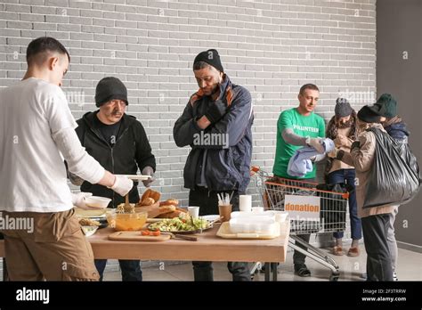 Giving Food And Clothes To Homeless Hi Res Stock Photography And Images