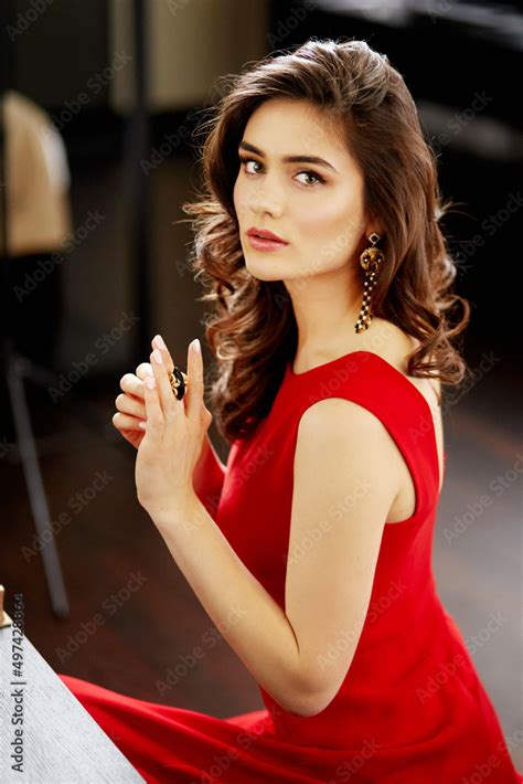 Beautiful Sexy Brunette In Red Dress With Healthy Curly Hair And Glamour Makeup Fashion Beauty