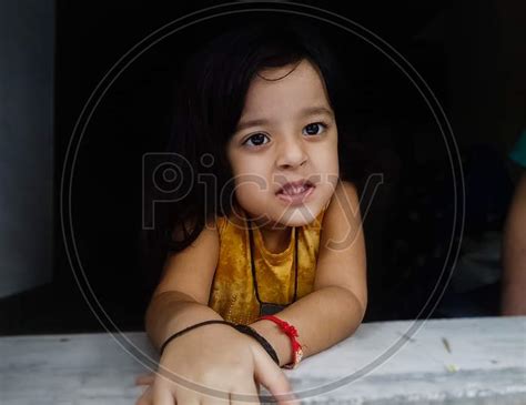 Image Of Cute Indian Girl Looking Through Window At Home Wg013590 Picxy
