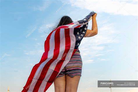 Rear View Of Woman With American Flag Star Outdoor Stock Photo