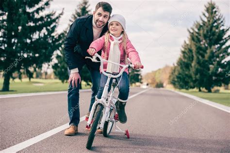 Padre Enseñando A Su Hija A Montar En Bicicleta 2024