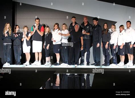 fashion designer giorgio armani foreground center poses with italian olympic team athletes