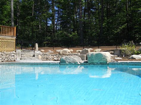 The bird uses the car to hide from the heat of the sun. Swimming pool and stone walls in North Conway, NH | Stone ...