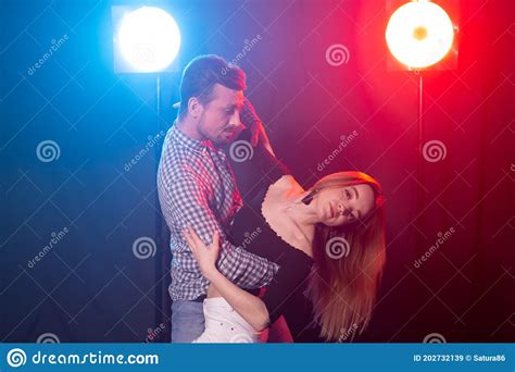 social dance bachata salsa kizomba zouk and tango concept man hugs woman while dancing