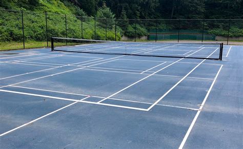 Can somebody explain why players don't trip up on these type of courts and why tennis balls don't make funny bounces when hitting the lines? Permanent pickleball lines going in at Cope and Adair ...