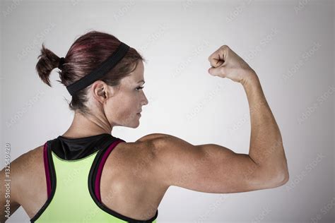 Beautiful Strong Muscular Woman Flexing Her Biceps And Arm Muscles