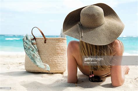 Woman Lying On Sandy Beach Mustique Grenadine Islands Photo Getty Images