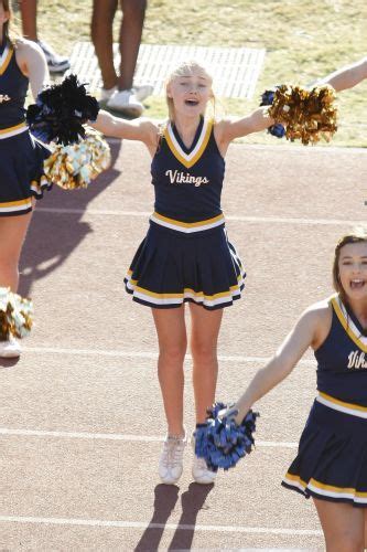 Three Cheerleaders Are Holding Their Pom Poms