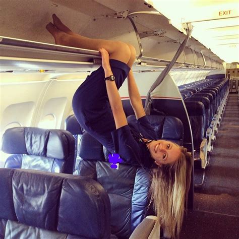 A Woman Is Hanging Upside Down On An Airplane With Her Legs In The Air