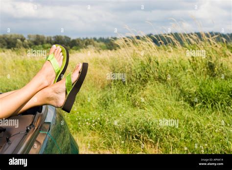 Woman Resting Feet On Car Stock Photo Alamy