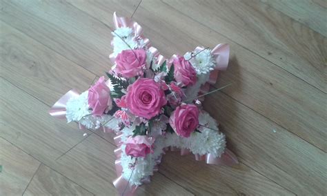 This amazing bespoke beer bottle funeral flower tribute is made from a 2 x 1ft (60 x 30cms) oasis designer board. Child's funeral tribute - star in pink #funeral flowers ...