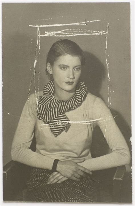An Old Black And White Photo Of A Woman Wearing A Scarf