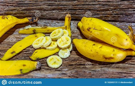 Fresh And Sliced Bananas On Aged Wooden Background Stock Image Image