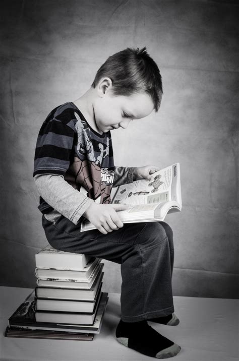 Schoolboy Is Sitting On Books Free Stock Photo Public Domain Pictures