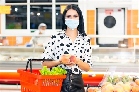 Premium Photo Young Woman In A Disposable Medical Mask Is Shopping At The Supermarket