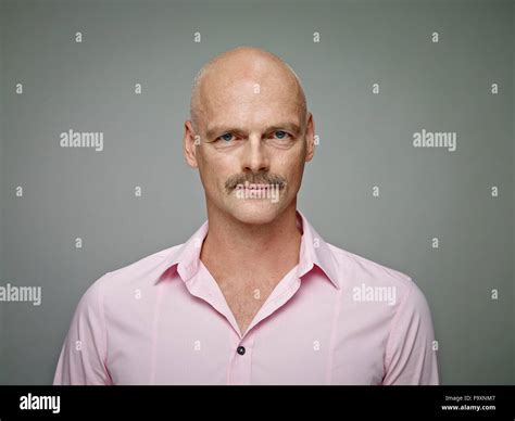 Portrait Of Bald Man With Moustache Wearing Pink Shirt Stock Photo Alamy