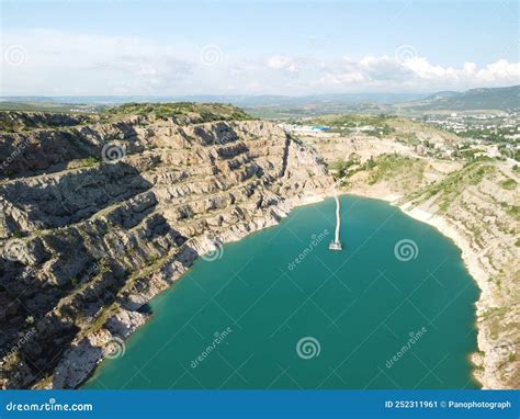 Aerial Top View On Opencast Mining Quarry With Flooded Bottom