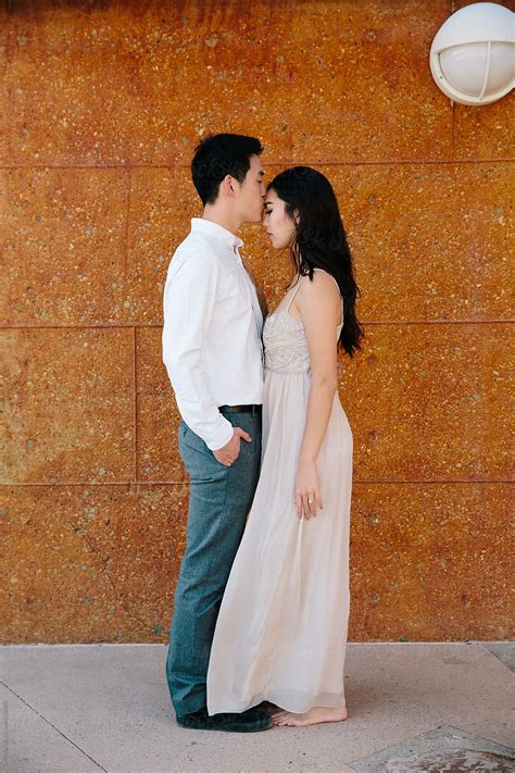 Young Asian Couple Facing Each Other And Kissing By Curtis Kim