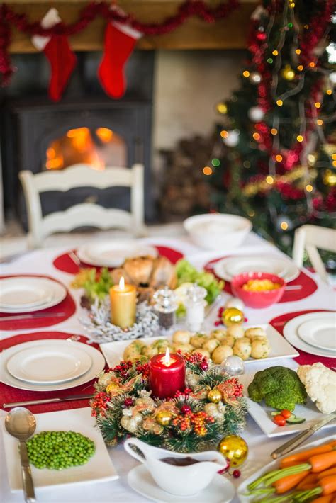 The christmas tree is an integral part of german christmas celebrations. Christmas dinner table with food at home in the living ...