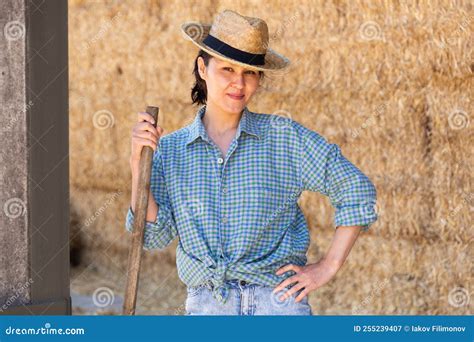 Cow Farm Owner Posing In The Barn Against Backdrop Of Hay Bales Stock