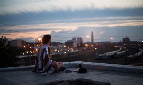 2160x3840 Girl Sitting On Rooftop Looking Towards Town 5k Sony Xperia X