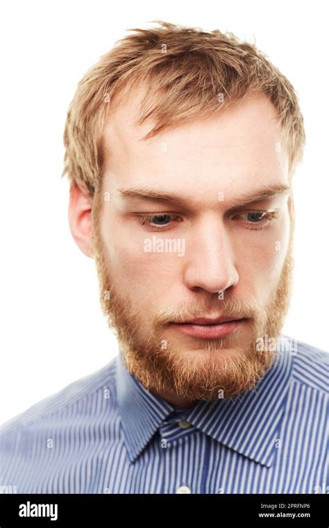 Ruggedly Handsome An Unshaven Young Man Looking Down Isolated On White