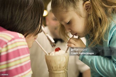Girls Sharing Milkshake High Res Stock Photo Getty Images