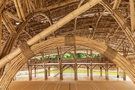 Arching Bamboo Trusses Are Left Exposed In Chiang Mai Sports Hall To