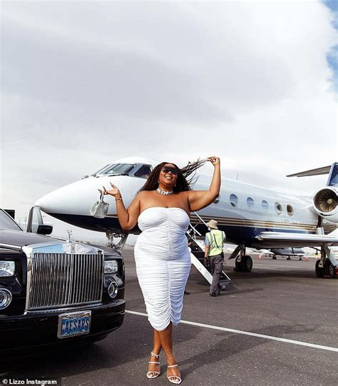 Lizzo Shows Off Her Curves In A White Dress While Dancing On An Airport