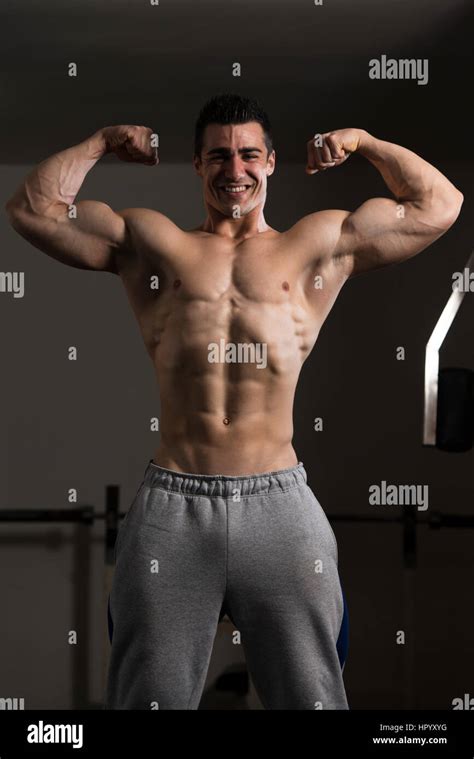 Portrait Of A Young Fit Man Showing Front Double Biceps Pose Muscular
