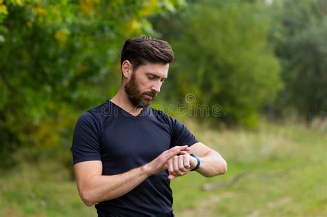 Sport Caucasian Man Looking Smart Watch At Modern Track Runner Using Use Smartwatch Fitness