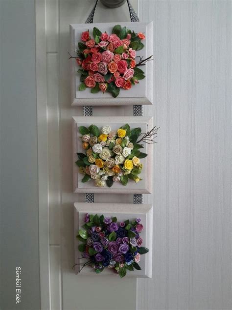 Three White Boxes With Flowers On Them Hanging From The Wall In Front Of A Door