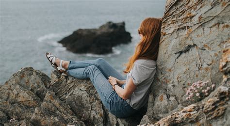 Woman Sitting On Cliff Pondering Mama Disrupt®