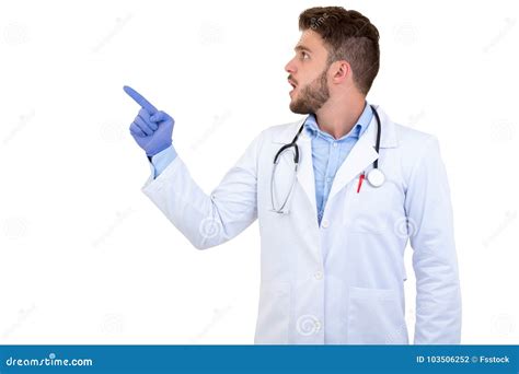 Portrait Of A Young Smiling Male Doctor Pointing Finger Away Isolated