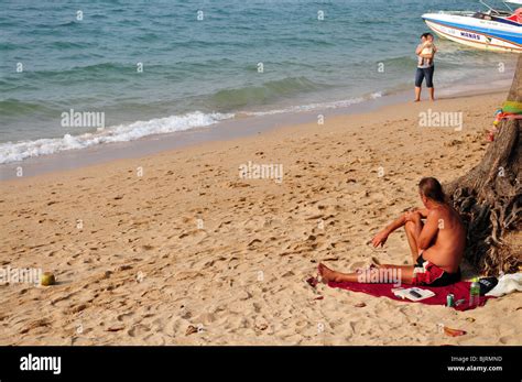 A Man Resting On Beach Under Palm Tree Pataya Thailand Beach Road Stock Photo Alamy